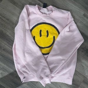 pink preppy sweatshirt with yellow smiley face